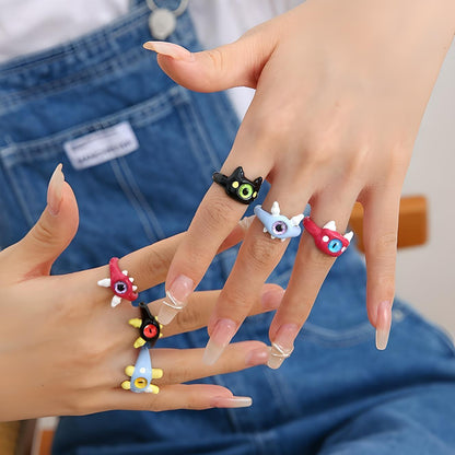 "Adorable hand showcasing a set of colorful cat rings, a fun and quirky addition to any casual outfit – perfect for cat lovers and fashion enthusiasts."