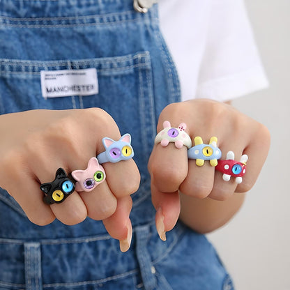 Colorful animal-themed finger rings displayed on two hands against a denim backdrop. Trendy, quirky jewelry perfect for playful fashion statements. #FashionAccessories #AnimalRings #QuirkyJewelry #StyleStatement