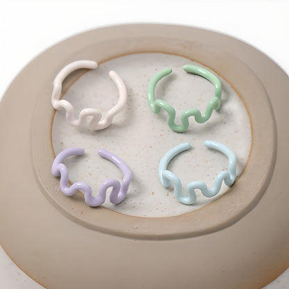 "Set of four trendy hair claw clips in pastel hues, elegantly displayed on a minimalist ceramic plate, perfect for a chic fashion accessory update."